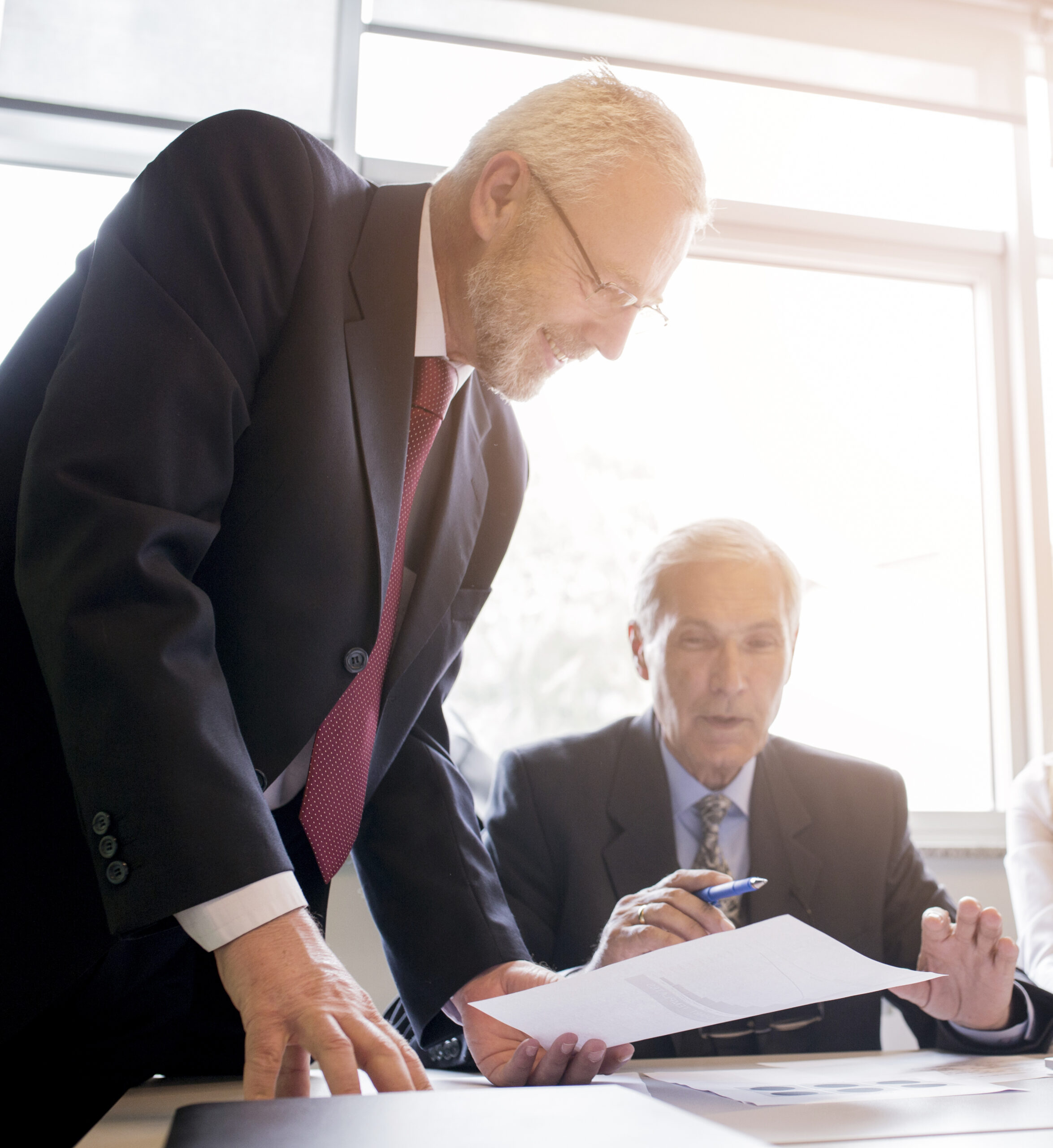 two-senior-businessman-discussing-document-office (1)